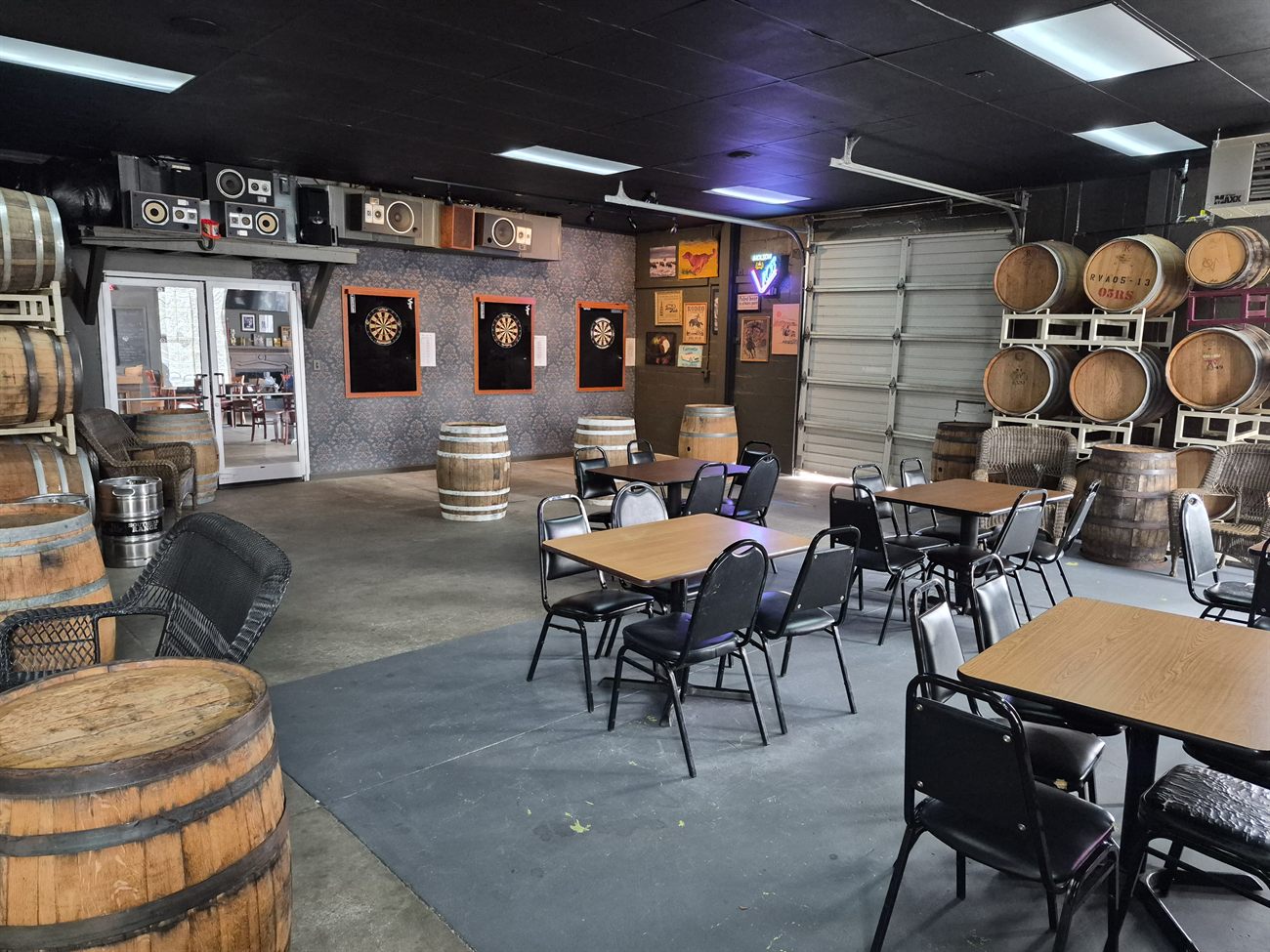 Barrel room with dartboards and bourbon barrels at Southern Range Brewing